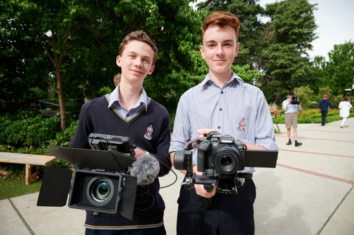 Picture of a student holding a camera rig.